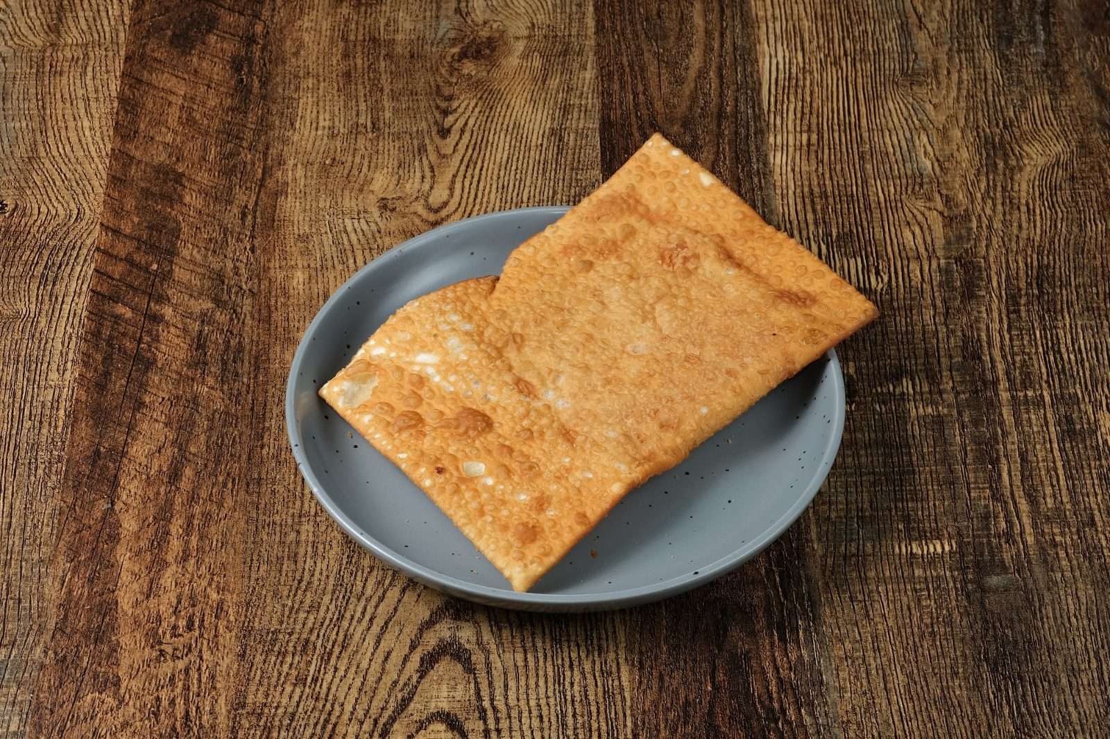 A golden Brazilian pastel on a plate