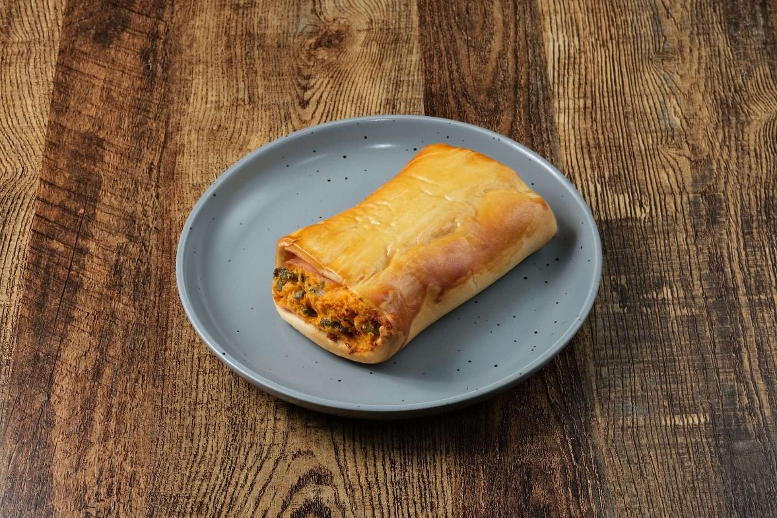 A baked Brazilian savoury pastry with filling